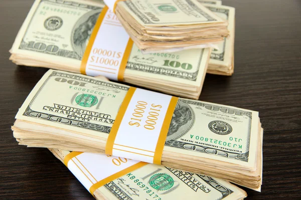 Stacks of money on wooden table — Stock Photo, Image