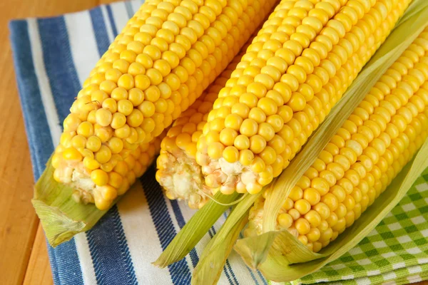Crude corns on napkin on wooden table — Stock Photo, Image