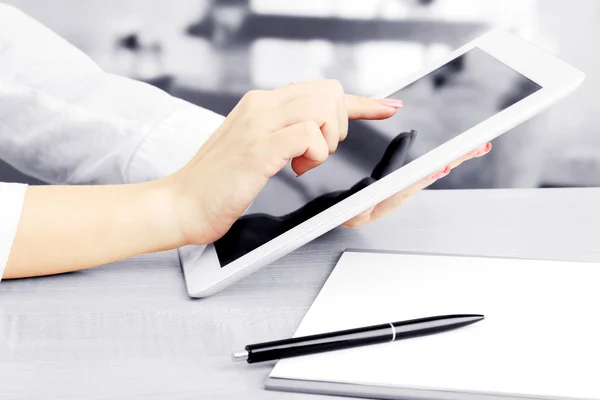 Female office worker using digital tablet in cafe in shades of grey — Stock Photo, Image