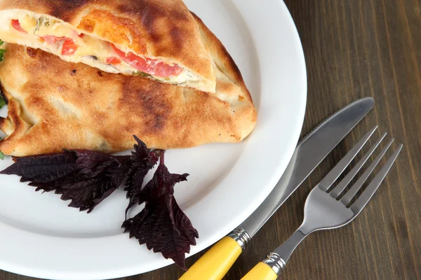 Pizza calzone on wooden table — Stock Photo, Image