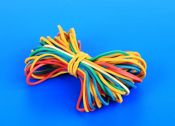 Colorful rubber bands on blue background — Stock Photo, Image