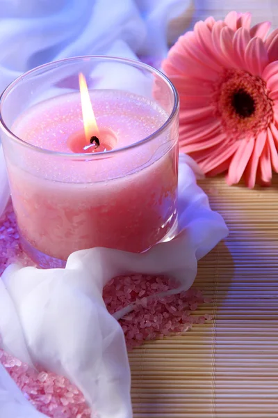 Beautiful candle with flower on white cloth, close up — Stock Photo, Image