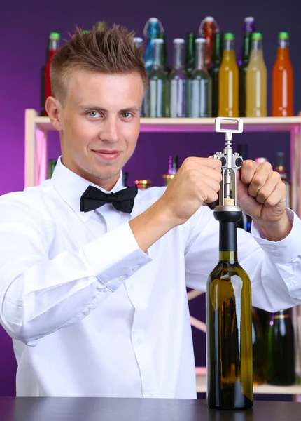 Bartender opens bottle of wine — Stock Photo, Image