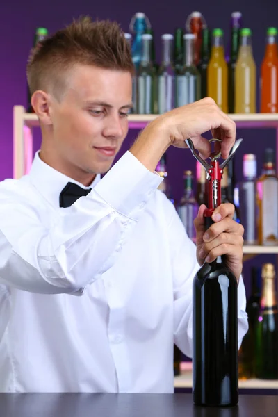 Bartender opens bottle of wine — Stock Photo, Image