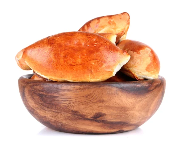 Fresh baked pasties in wooden bowl, isolated on white — Stock Photo, Image
