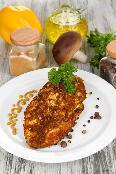 Roasted chicken fillets on white plate and vegetables, on wooden background — Stock Photo, Image