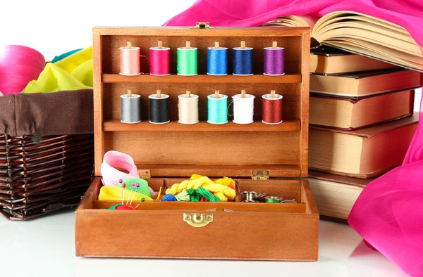 Sewing kit in wooden box with books and cloth isolated on white — Stock Photo, Image