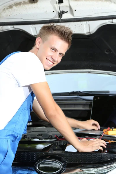 Mecánico profesional de automóviles que trabaja en el servicio de reparación de automóviles — Foto de Stock