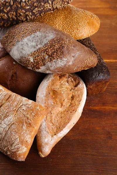 Much bread on wooden board — Stock Photo, Image