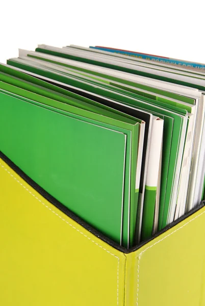 Magazines and folders in green box, isolated on white — Stock Photo, Image