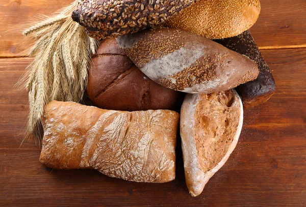 Much bread on wooden board — Stock Photo, Image