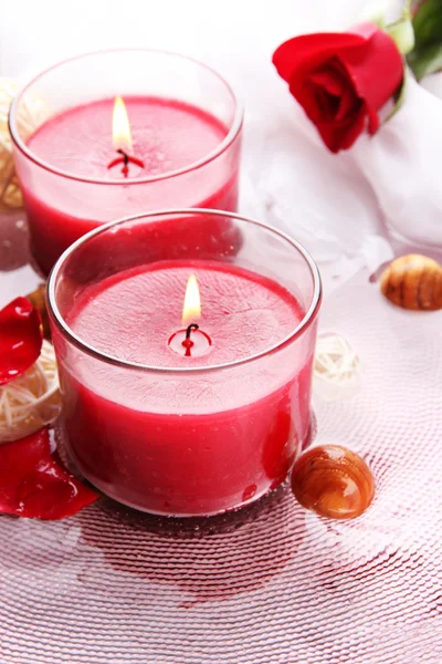 Beautiful red candles with flower petals in water Stock Image