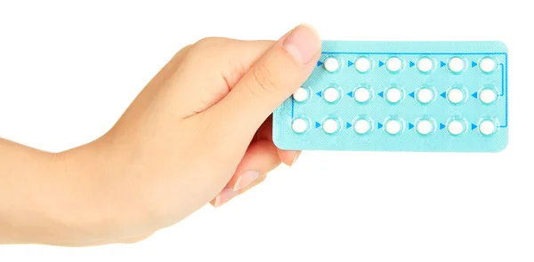 Pastillas hormonales en mano femenina aisladas en blanco —  Fotos de Stock