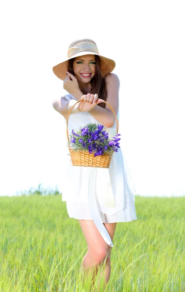 필드에 꽃을 가진 아름 다운 젊은 여자의 초상화 — 스톡 사진