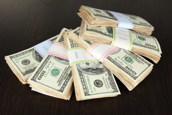 Stacks of money on wooden table — Stock Photo, Image