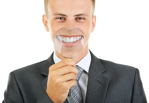 Businessman with magnifying glass zooming on his smile — Stock Photo, Image