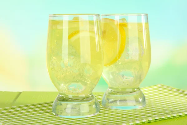 Delicious lemonade on table on light blue background — Stock Photo, Image