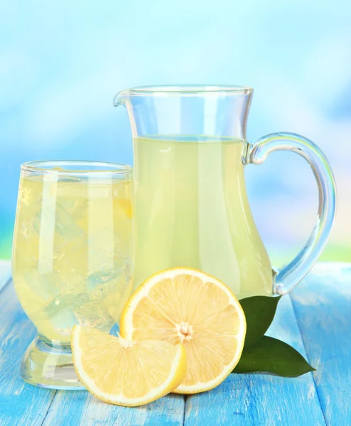 Delicious lemonade on table on blue background — Stock Photo, Image