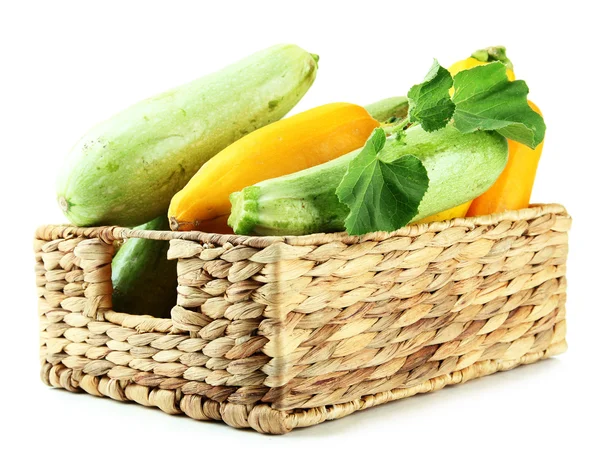 Raw yellow and green zucchini in wicker crate, isolated on white — Stock Photo, Image