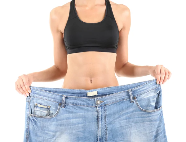 Menina magro com jeans grandes isolado no branco — Fotografia de Stock