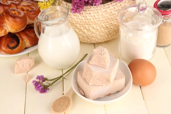 Dry yeast with pastry and baking ingredients on wooden table close-up — Stock Photo, Image