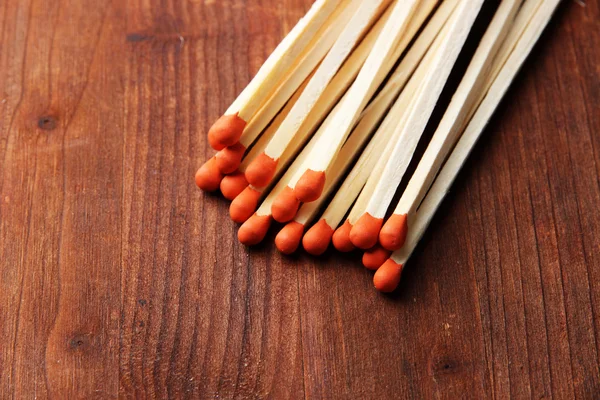 Long matches for fireplace on wooden background — Stock Photo, Image