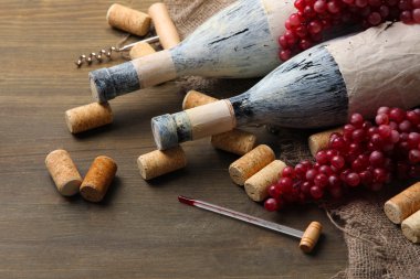 eski şişe şarap, üzüm ve ahşap zemin üzerinde mantarlar