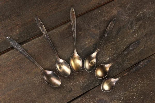 Vintage metal spoons on wooden table close-up — Stock Photo, Image