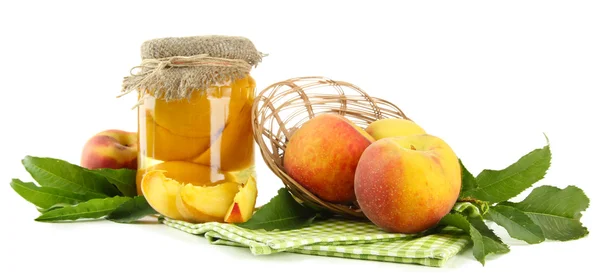 Jar of canned peaches and fresh peaches, isolated on white — Stock Photo, Image