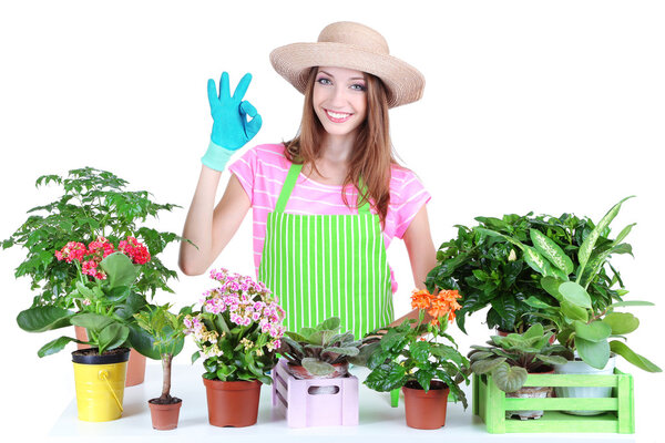 Beautiful girl gardener with flowers isolated on white