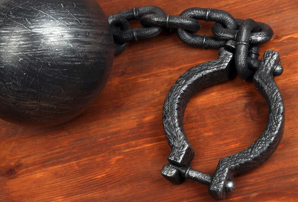 Ball and chain on wooden background — Stock Photo, Image