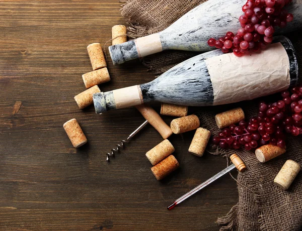 eski şişe şarap, üzüm ve ahşap zemin üzerinde mantarlar