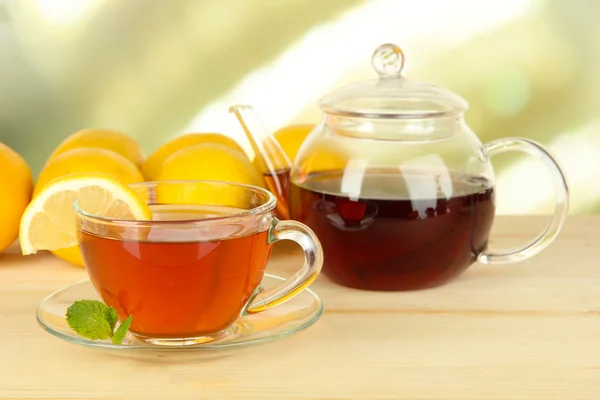 Tasse Tee mit Zitrone auf dem Tisch auf hellem Hintergrund — Stockfoto