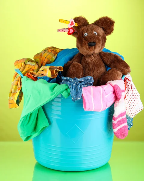 Blue laundry basket on green background — Stock Photo, Image