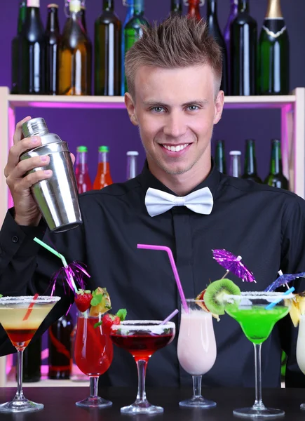 Portrait of handsome barman with different cocktails cocktail, at bar — Stock Photo, Image