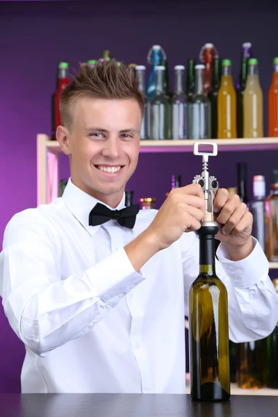 Bartender opens bottle of wine — Stock Photo, Image