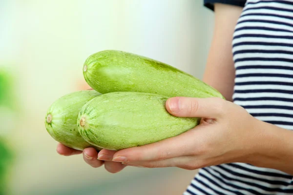 Woman hand holding raw zucchini, outdoors — Stock Photo, Image