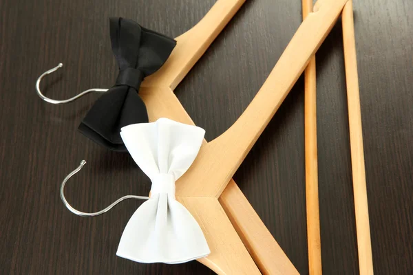 木製ハンガー、木製の背景上に黒と白の弓の関係 — ストック写真