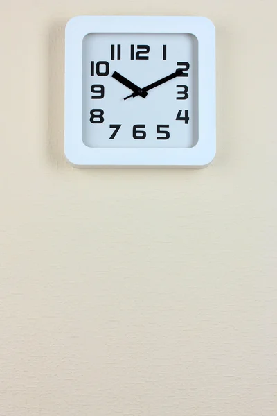 Office clock on color wall background — Stock Photo, Image