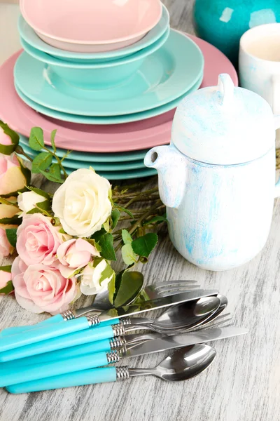 Lots beautiful dishes on wooden table close-up — Stock Photo, Image