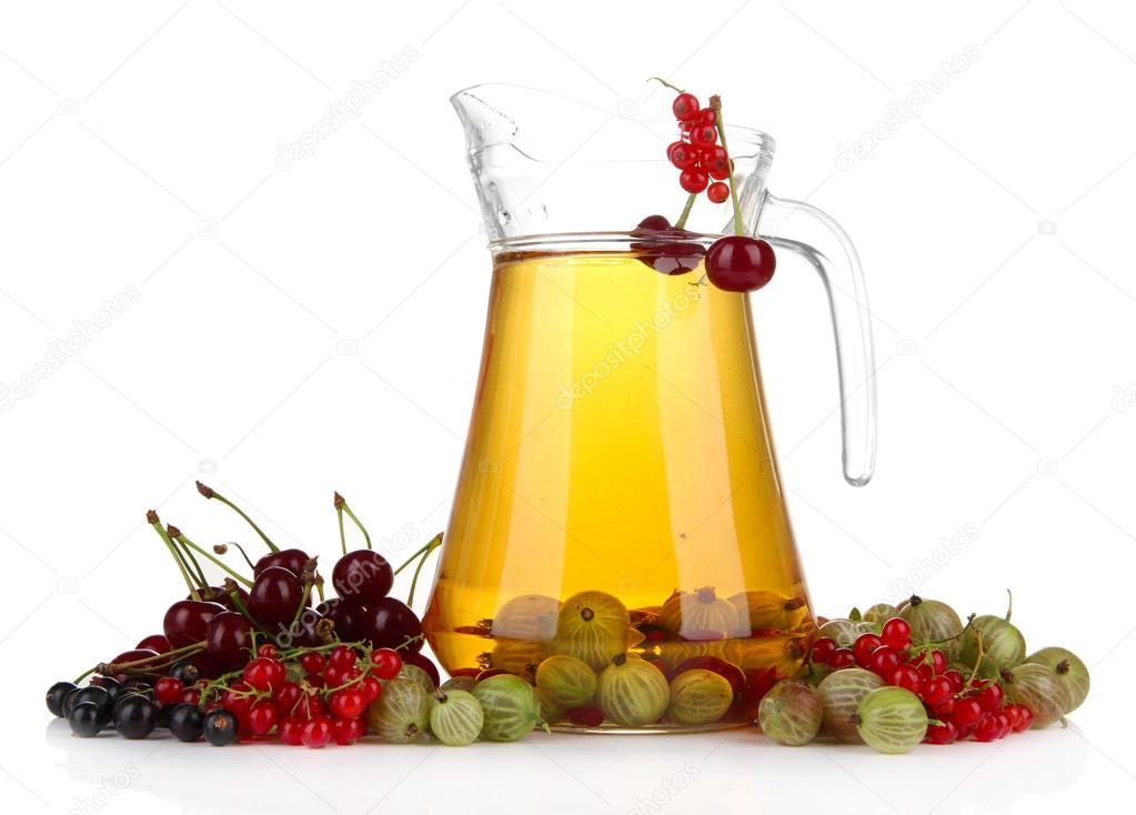 Glass pitcher of compote with different summer berries isolated on white
