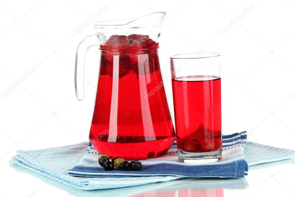 Pitcher and glass of compote on napkins isolated on white