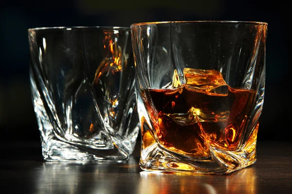 Glasses of whiskey, on dark background — Stock Photo, Image