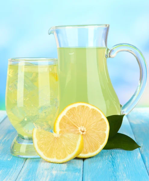 Delicious lemonade on table on blue background — Stock Photo, Image