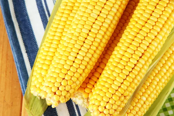 Crude corns on napkin on wooden table — Stock Photo, Image