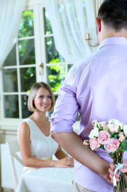 Handsome man with bouquet roses for his girlfriend