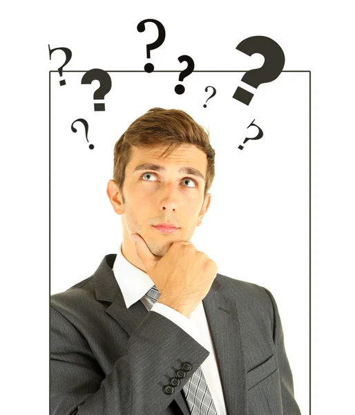 Young man thinking surrounded by question marks isolated on white — Stock Photo, Image