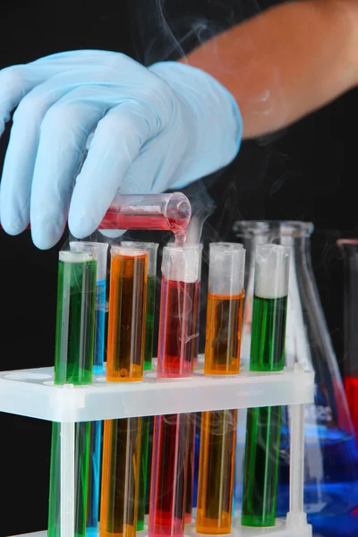 Laboratory test tubes on black background — Stock Photo, Image