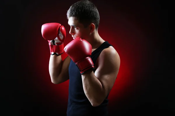 Handsome young muscular boxer on dark background — Stock Photo, Image