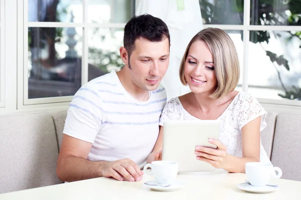 Young couple taking photo with tablet at home — Stok fotoğraf